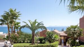 A resort with palm trees, a view of the sea, and Mediterranean-style buildings. - Eurohotel Theo Hotel (Chania)