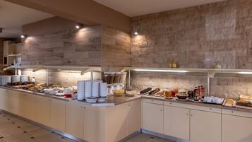 A buffet setup with various food items and condiments.