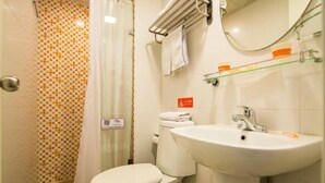 A bathroom with a toilet, sink, and shower area. - Home Inn Jinsong (BEIJING)