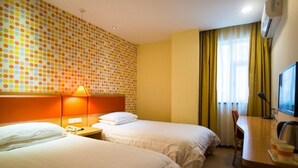 A hotel room with two beds, a desk, a chair, and a TV. - Home Inn Jinsong (BEIJING)