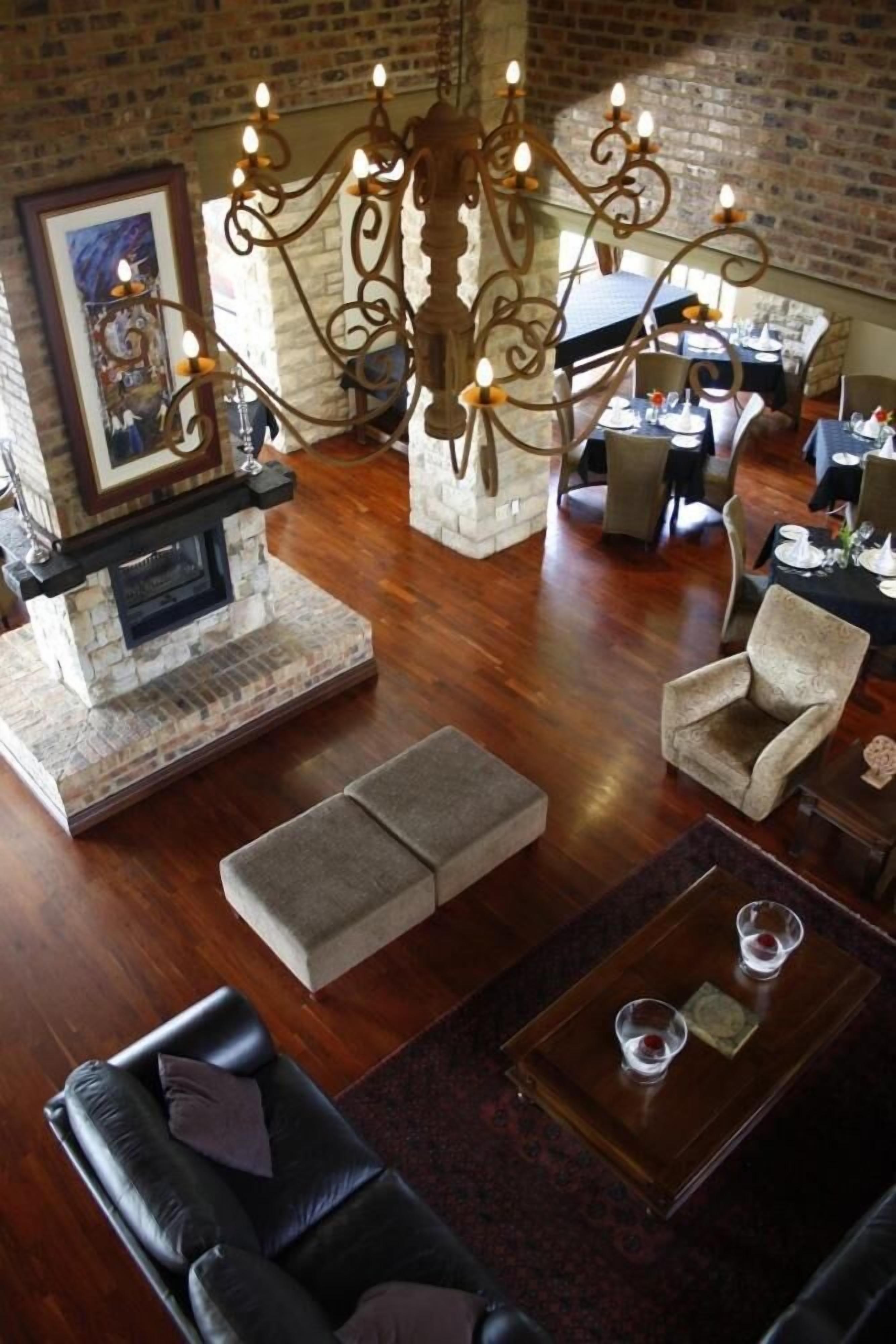 A cozy living room with a fireplace, comfortable seating, and a dining area.