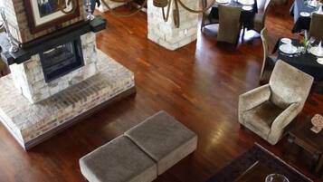 A cozy living room with a fireplace, comfortable seating, and a dining area.