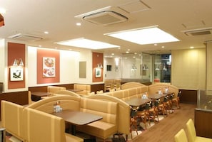 A restaurant with booth seating and tables, featuring a modern interior design with recessed lighting and framed pictures on the walls. - Jr-east Hotel Mets Urawa (Saitama)