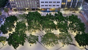 An aerial view of a landscaped area with trees and a paved walkway, surrounded by buildings. - Capetonian Hotel (Cape Town)