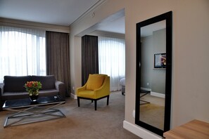 A modern living room with a sofa, armchair, and a coffee table. - Capetonian Hotel (Cape Town)