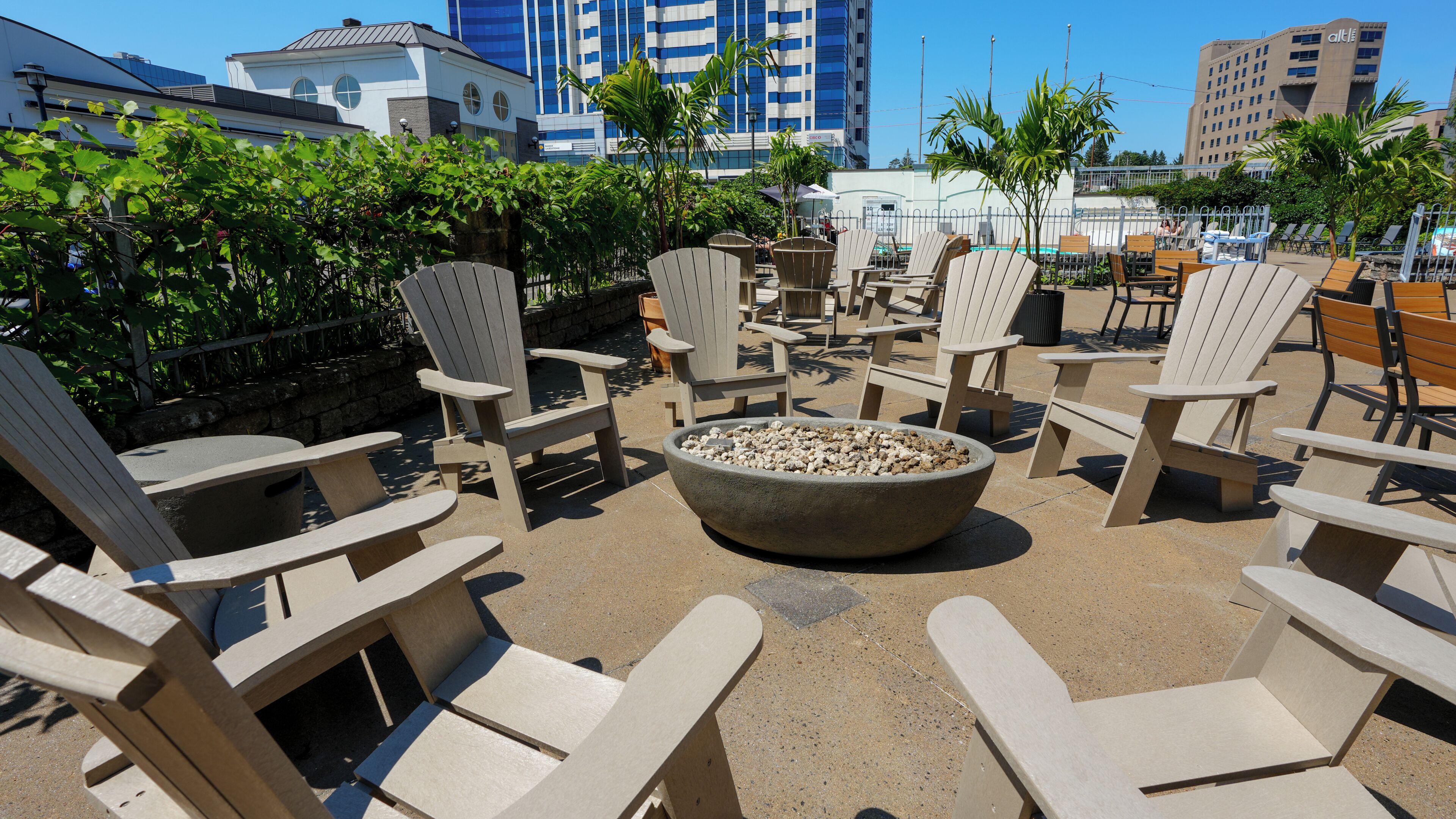 A patio area with Adirondack chairs and a fire pit.