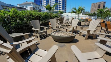 A patio area with Adirondack chairs and a fire pit.