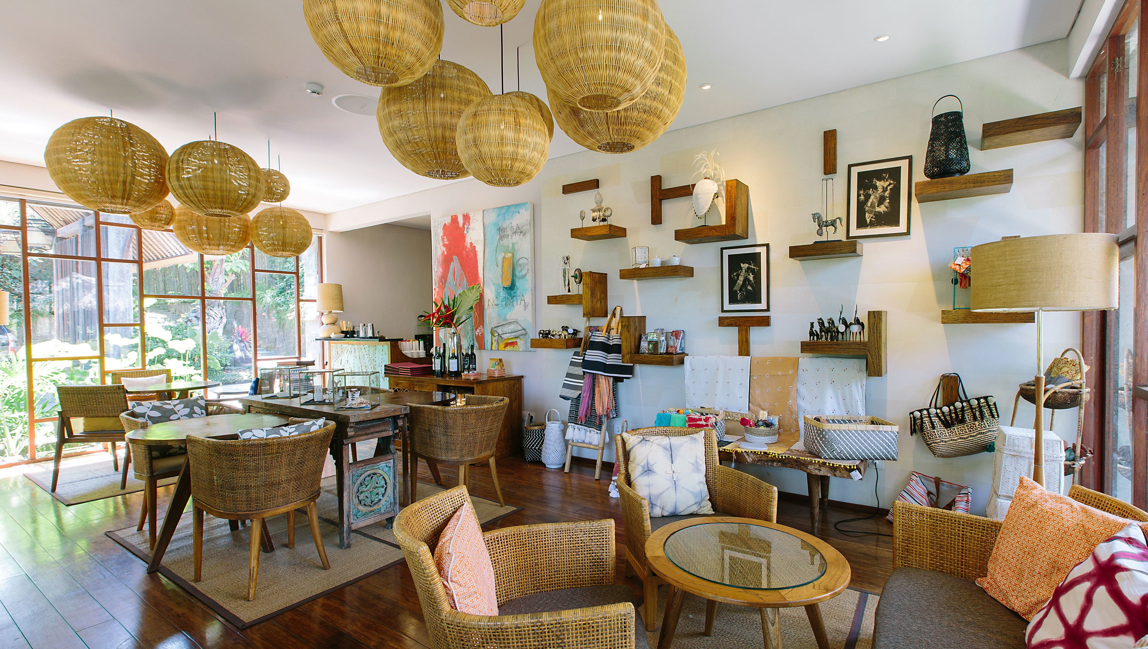 A spacious room with wicker furniture, a dining area, and various decorative items on shelves.