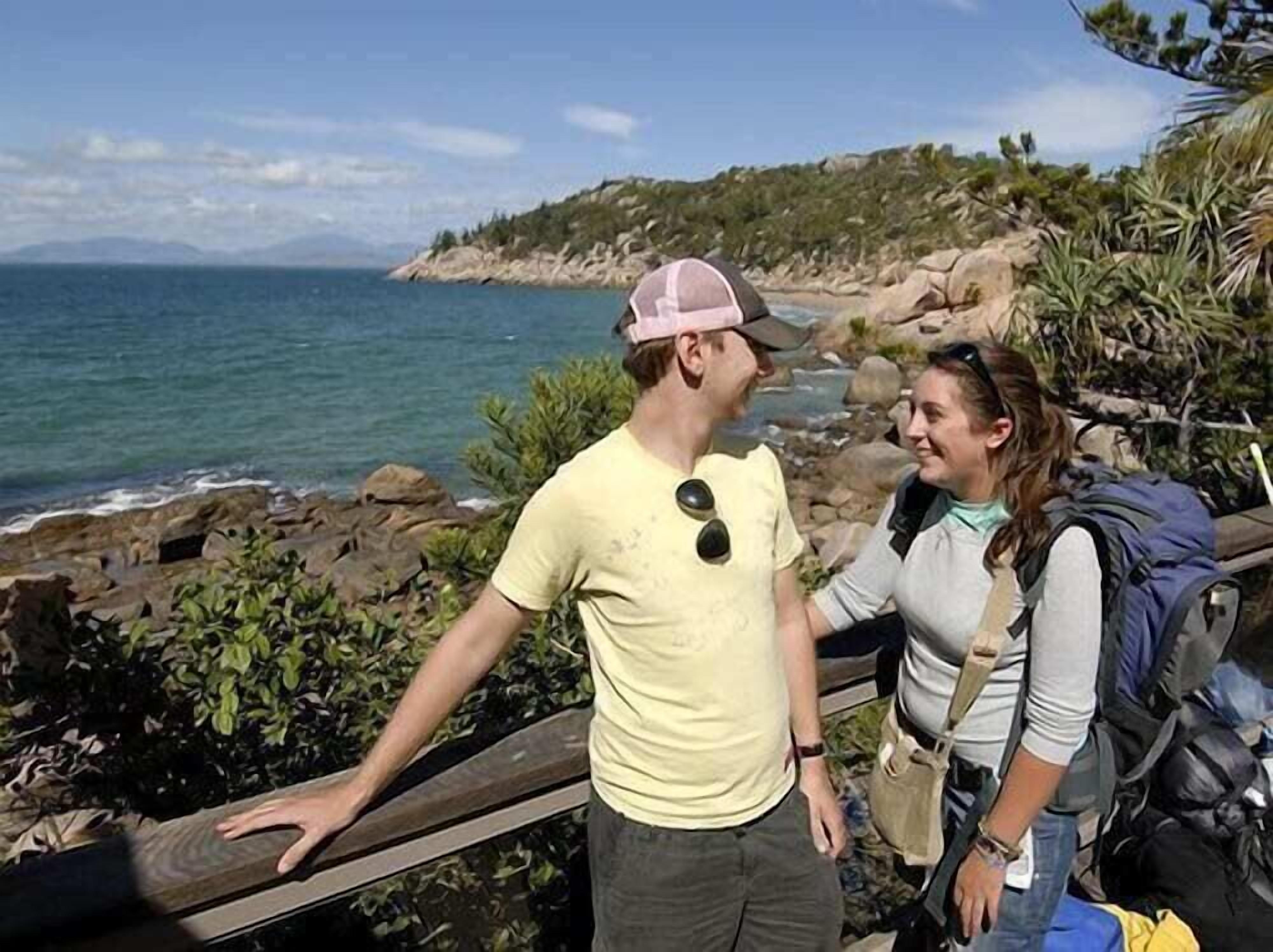 A coastal hiking trail with rocky terrain and a view of the ocean.