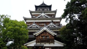 A traditional Japanese castle with multiple tiers and wooden construction. - Hiroshima Capsule Hotel & Sauna New Japan EX - Caters to Men (Hiroshima)
