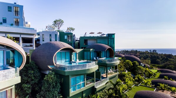 A modern resort with unique dome-shaped structures, a pool, and lush greenery. - Crest Resort & Pool Villas (Patong)