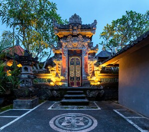 A traditional Balinese temple entrance with ornate carvings and a central door. - The Tunjung Ubud Retreat (Ubud)