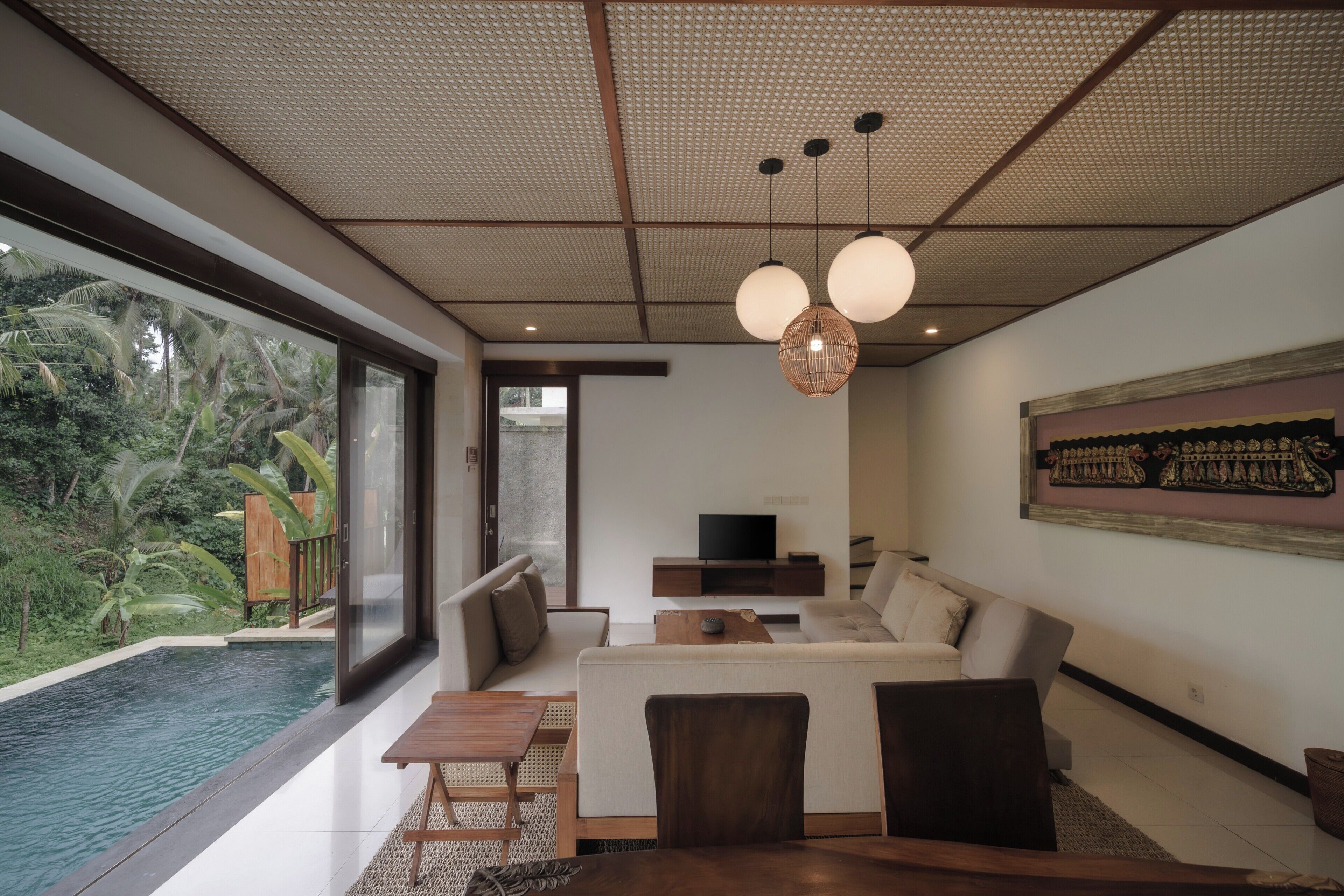 A modern living room with a large window, a pool, and a television.