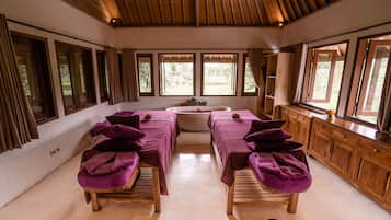 Relax in a serene space with two massage tables, a wooden cabinet, and a sink for your convenience.