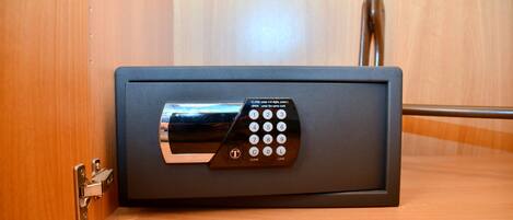 A safe with a keypad lock on a wooden surface.