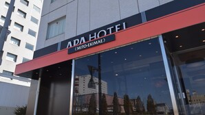 The exterior of the APA HOTEL with a modern design, featuring a prominent red awning and large glass windows reflecting the surrounding buildings. - APA Hotel Mito-ekimae (Mito)