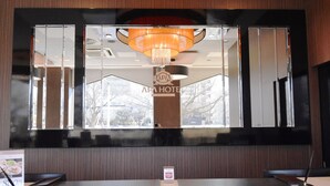 A reception desk with a large mirror reflecting a chandelier and the sign "ARA HOTEL". - APA Hotel Mito-ekimae (Mito)