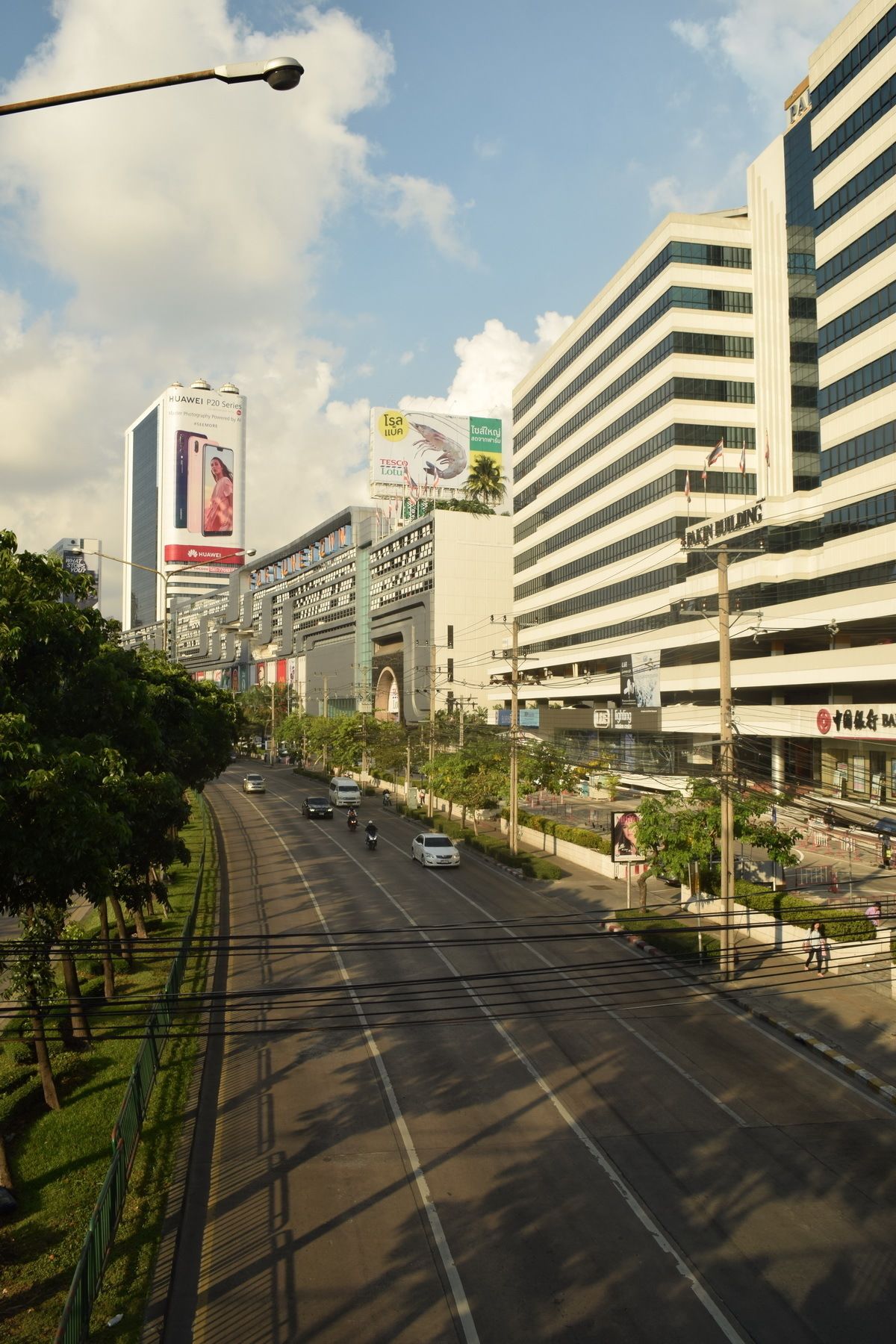 A multi-story building with a modern architectural design, featuring a prominent signboard and a series of windows.