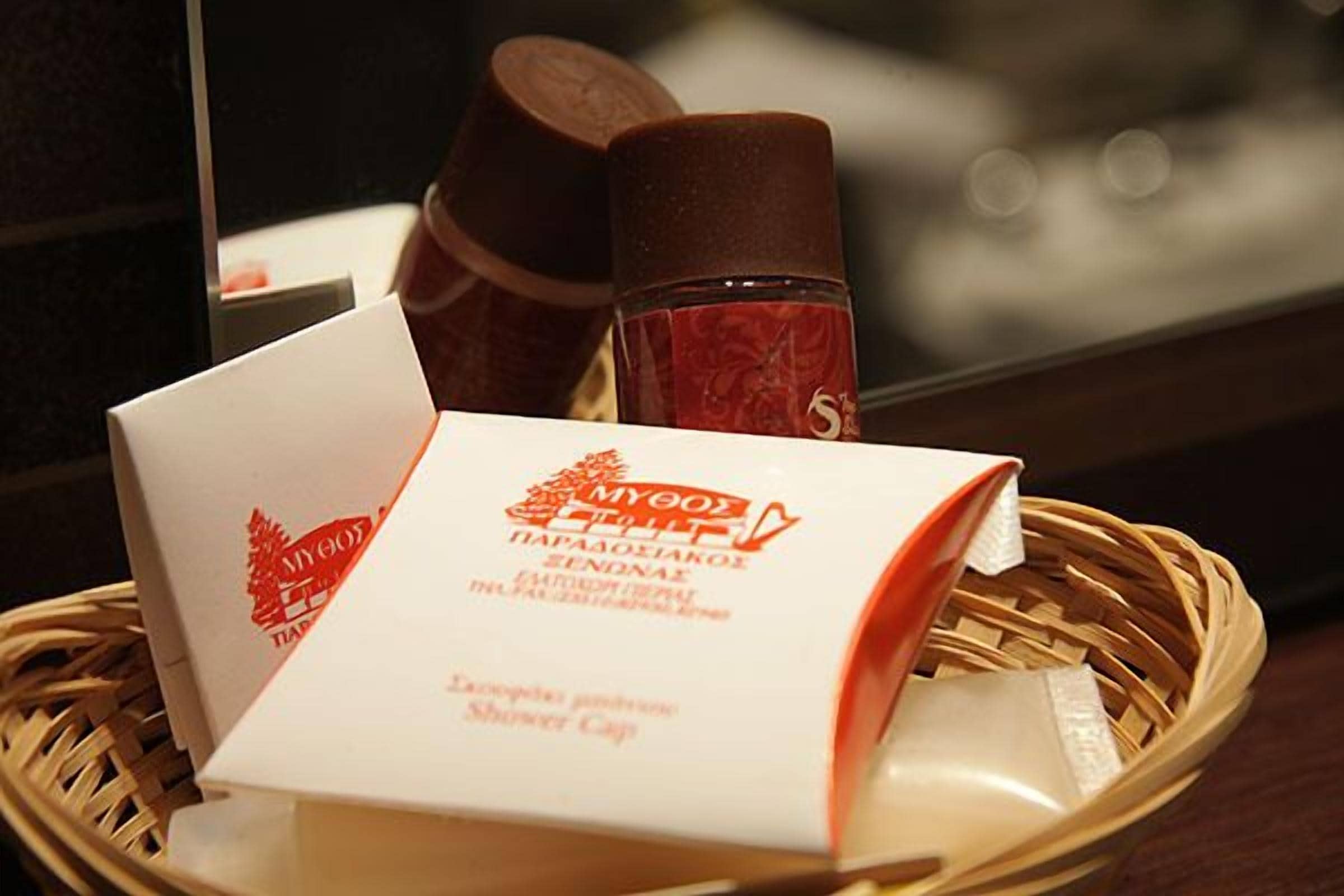 A basket containing a white box with red text and two brown bottles.