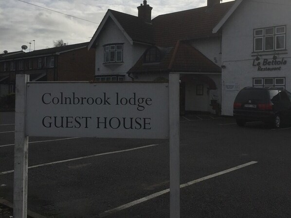 A sign for Colnbrook Lodge Guest House.