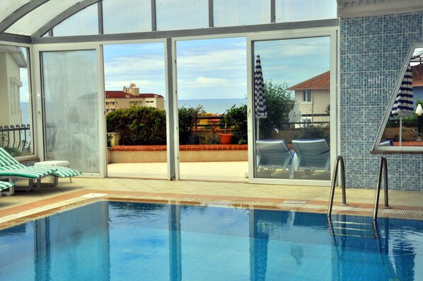 Indoor pool, outdoor pool, pool umbrellas, pool loungers