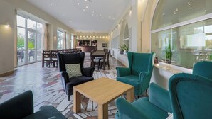 A spacious lobby with a bar area, seating arrangements, and large windows. - Hotel NAT Sarbinowo (Sarbinowo)