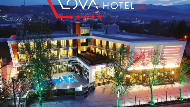 A modern hotel with a pool, multiple balconies, and a view of the surrounding area. - Lova Hotel SPA (Yalova)