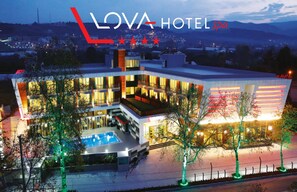 A modern hotel with a pool, multiple balconies, and a view of the surrounding area. - Lova Hotel SPA (Yalova)