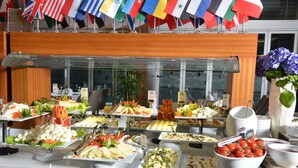 A buffet with various food items and a selection of flags. - Lova Hotel SPA (Yalova)