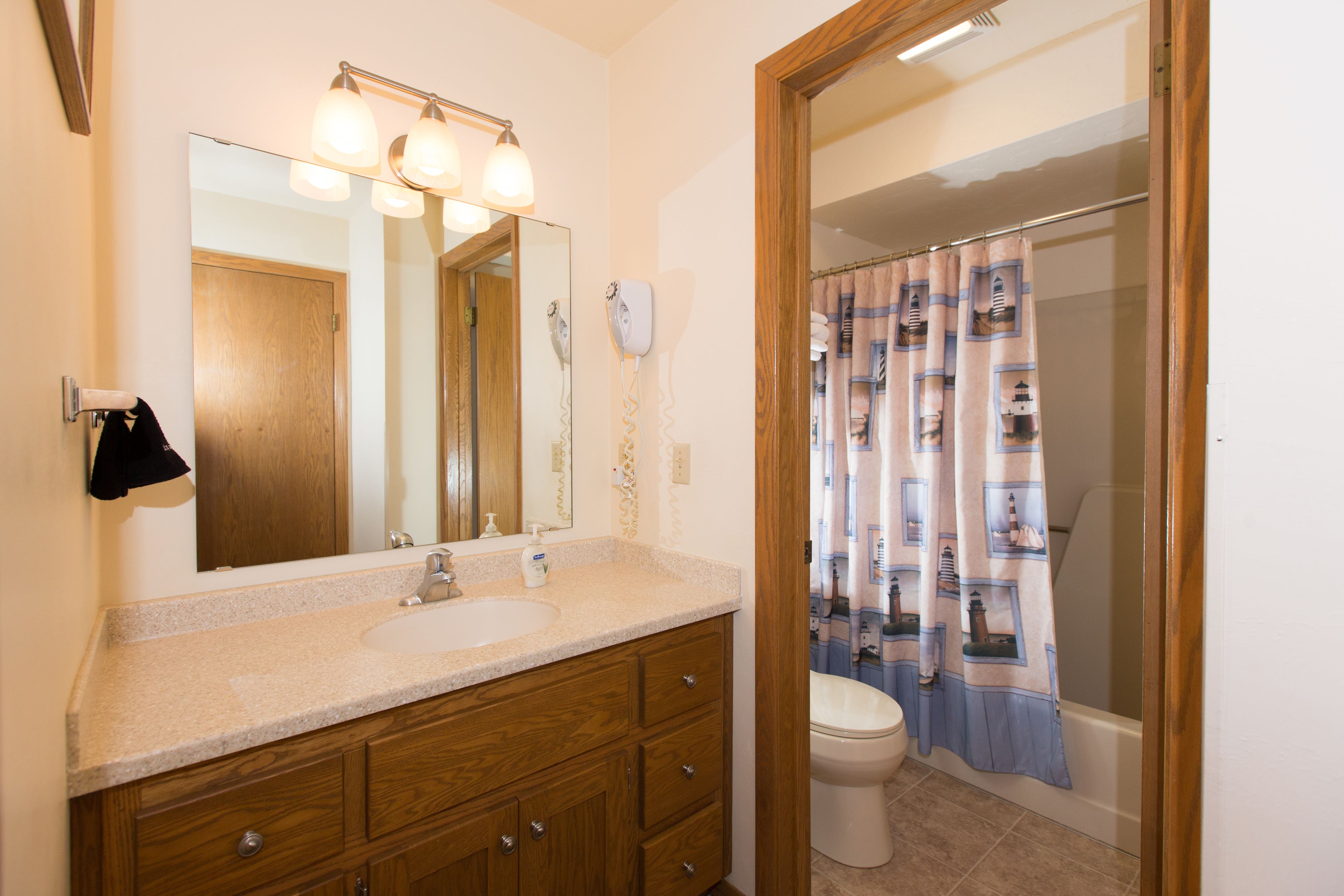 A bathroom with a sink, mirror, and toilet.