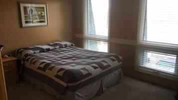 Desk, iron/ironing board, bed sheets