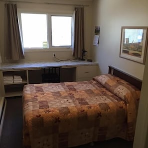 Desk, iron/ironing board, bed sheets