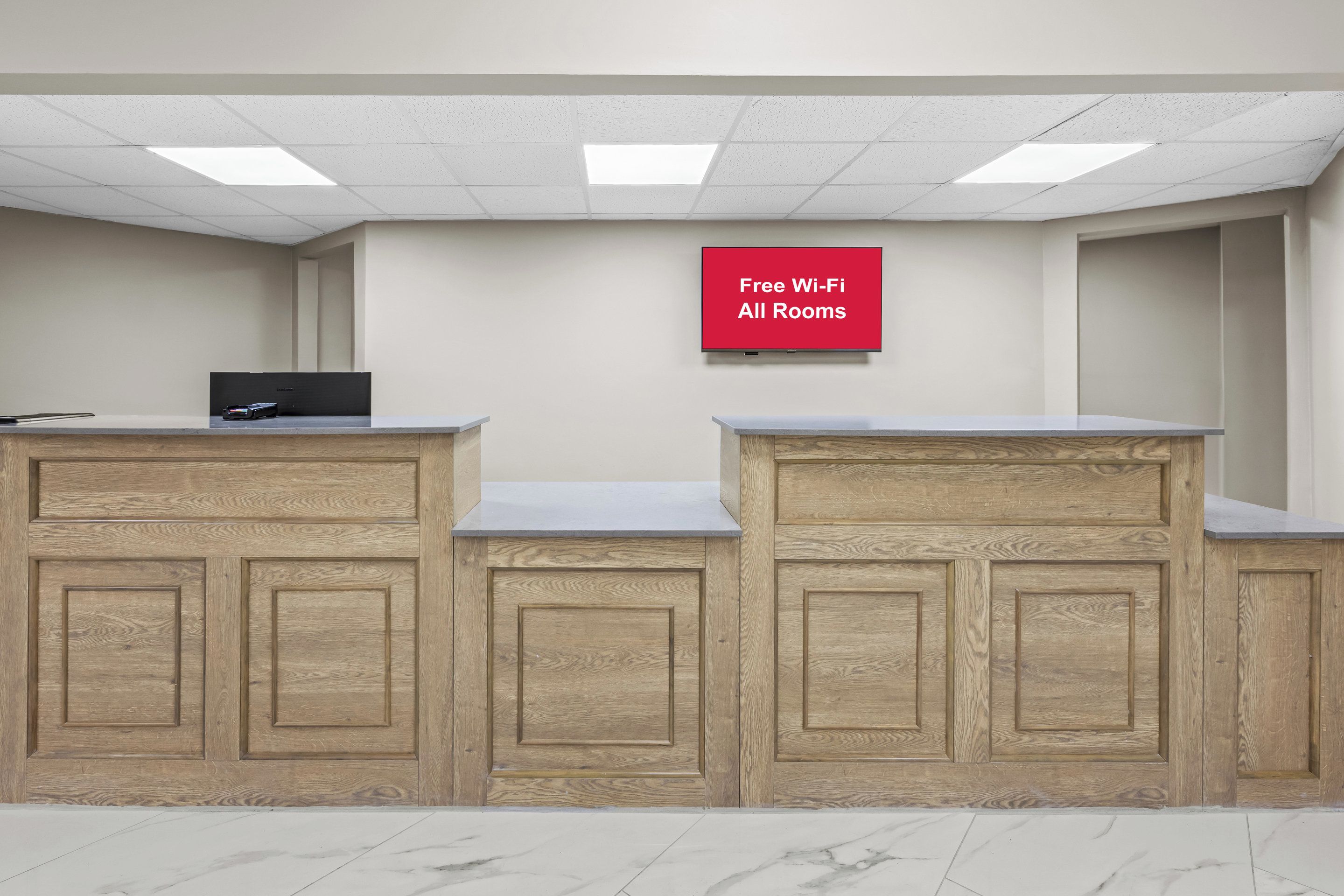 A reception area with a sign indicating free Wi-Fi in all rooms.