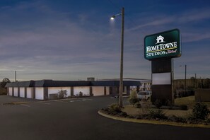 A building with a sign reading "Home Towne Studios." - HomeTowne Studios by Red Roof Athens, TN (Athens)