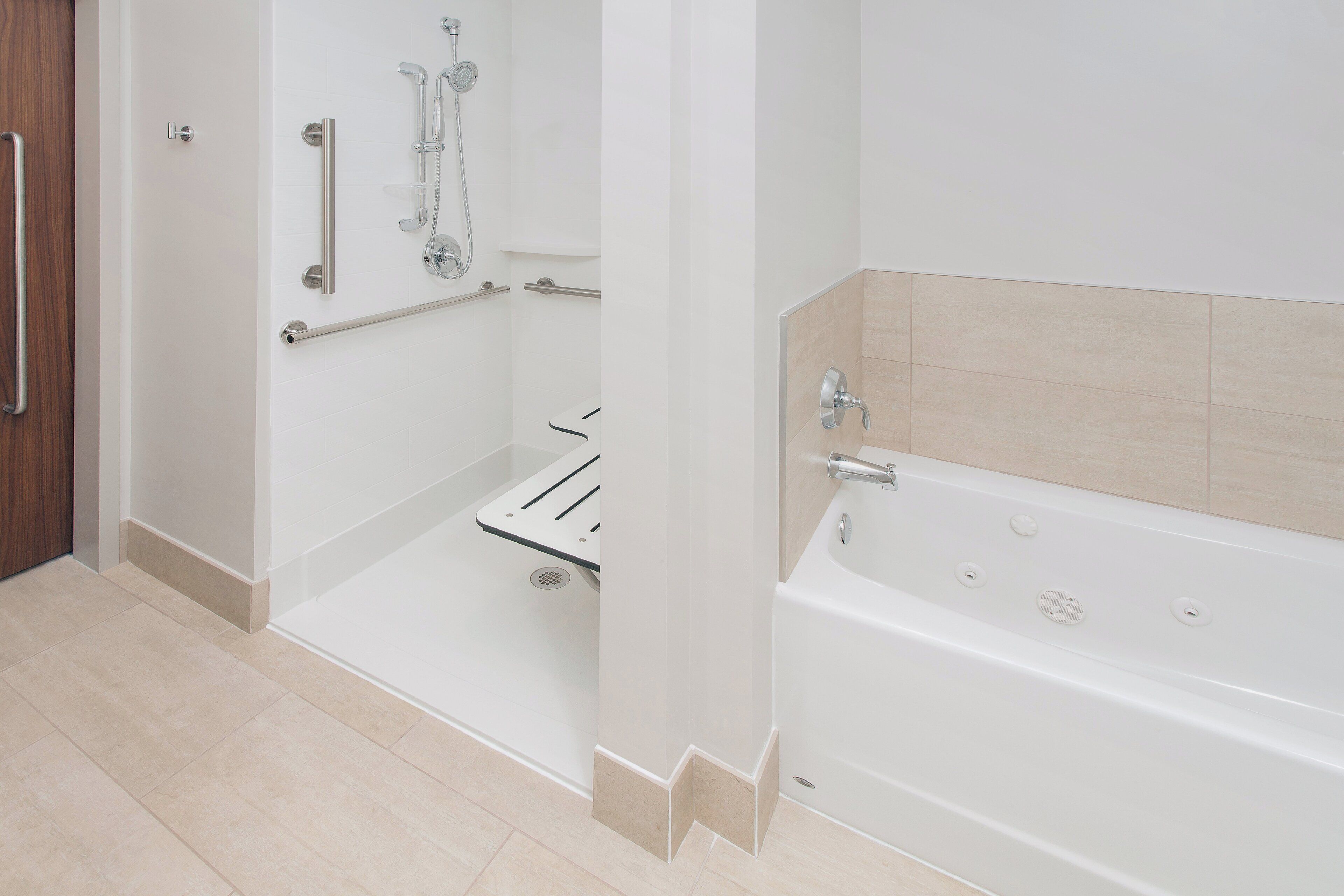 A modern bathroom with a walk-in shower, a bathtub, and a toilet.