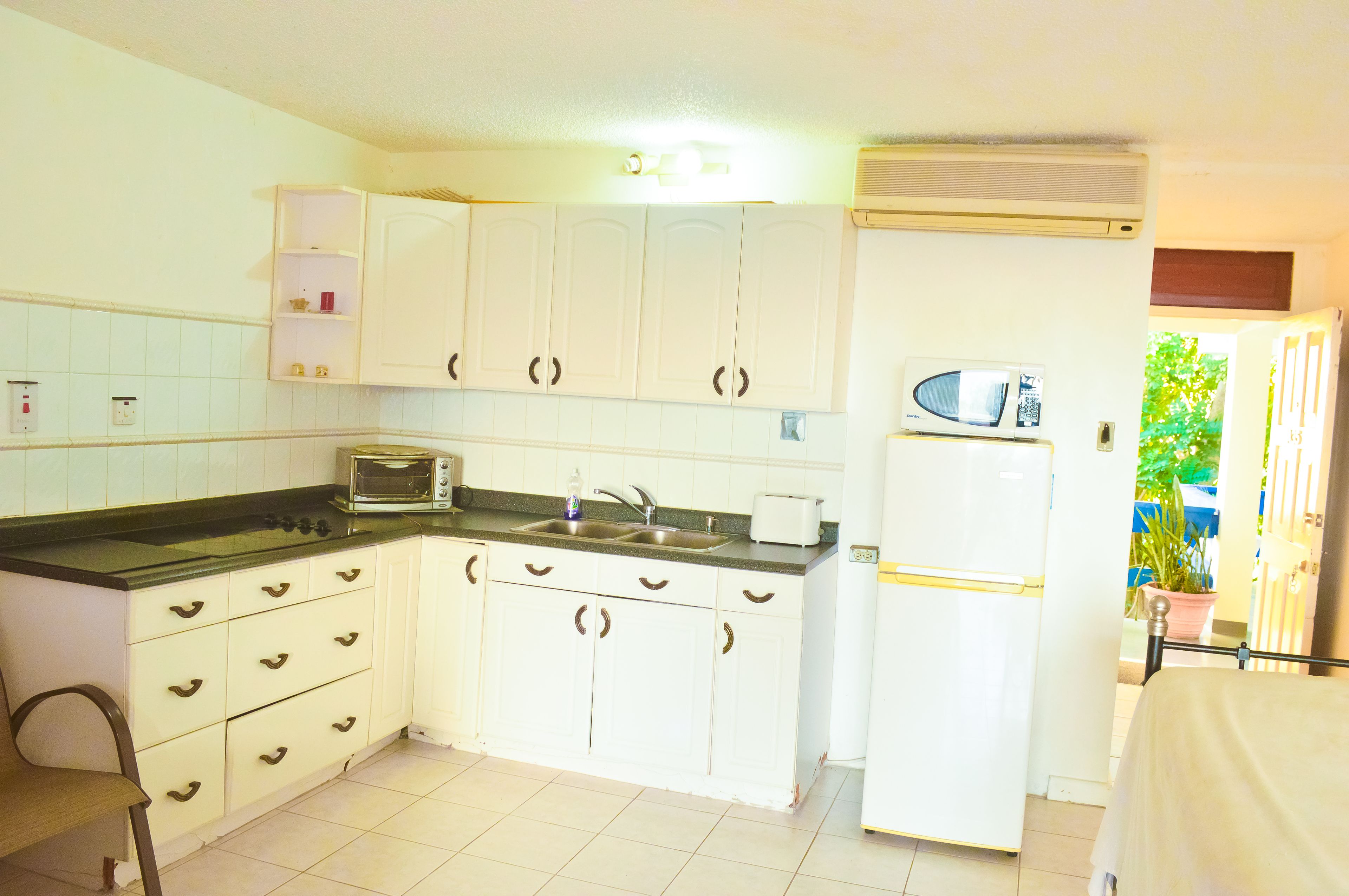 comfort apartment, ocean view | private kitchen | full-sized fridge, stovetop