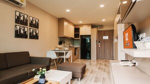 A compact living space with a sofa, a dining table, and a kitchenette. - B2 Mountain Pano Residence Chiang Mai (Chiang Mai)