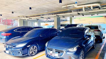 A parking garage with multiple cars parked in designated spaces.