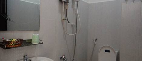 A bathroom with a sink, toilet, and shower.