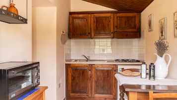 Apartment, 1 Bedroom (Olivo D) | Private kitchen | Full-sized fridge, stovetop, electric kettle, high chair