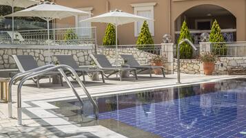 Outdoor pool, open 10:00 AM to 7:00 PM, pool umbrellas, pool loungers