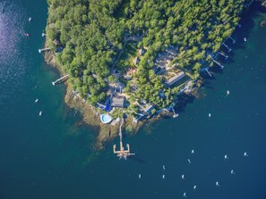 An aerial view of a coastal area with a swimming pool, dock, and several boats. - Linekin Bay Resort (Boothbay Harbor)
