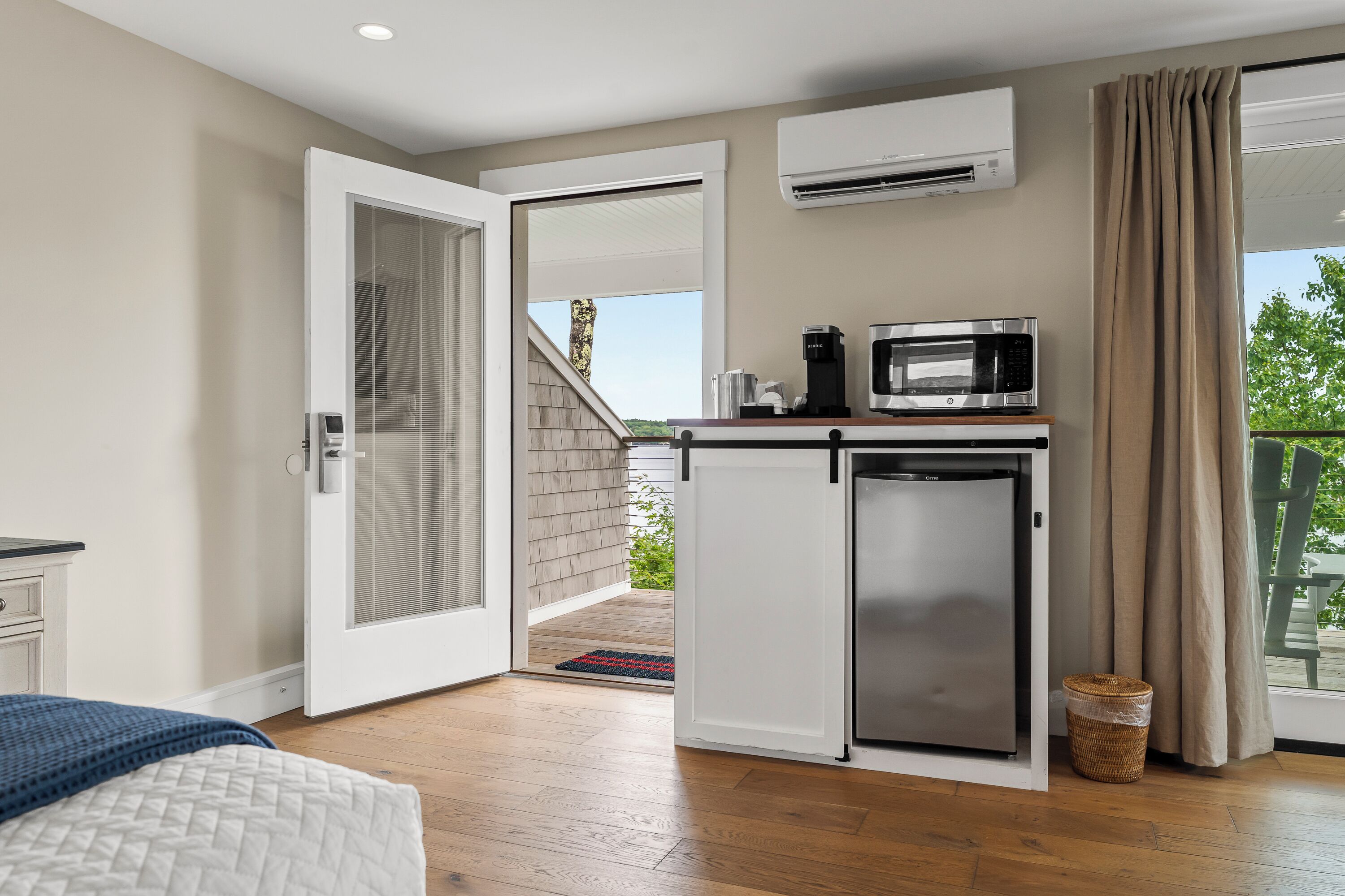 A compact kitchenette with a microwave, coffee maker, and a small refrigerator.