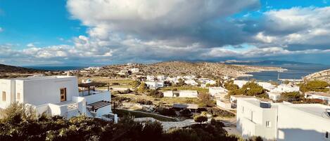 A coastal town with white buildings, a clear sky, and a view of the sea.