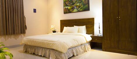 A bedroom with a large bed, a nightstand, a wardrobe, and a painting on the wall.