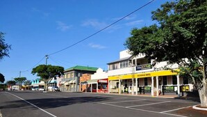 A street view with a hotel named "Exchange Hotel" and a business named "Little Bottler." - Exchange Hotel Toogoolawah (Toogoolawah)