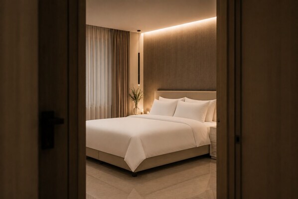 A hotel room with a bed, curtains, a vase with flowers, and a nightstand.