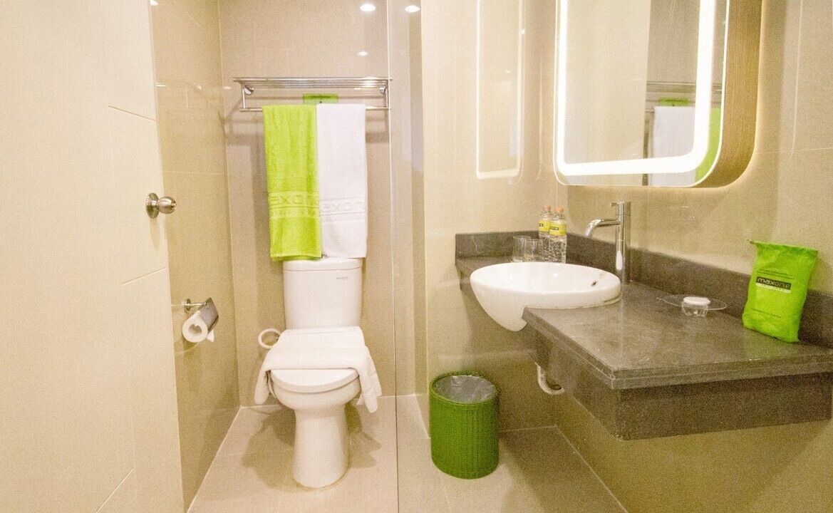 A modern bathroom with a toilet, bidet, and sink.