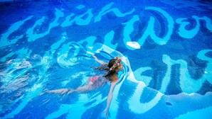 A person swimming in a pool with a clear blue water surface. - The Surfjack Hotel & Swim Club (Honolulu)