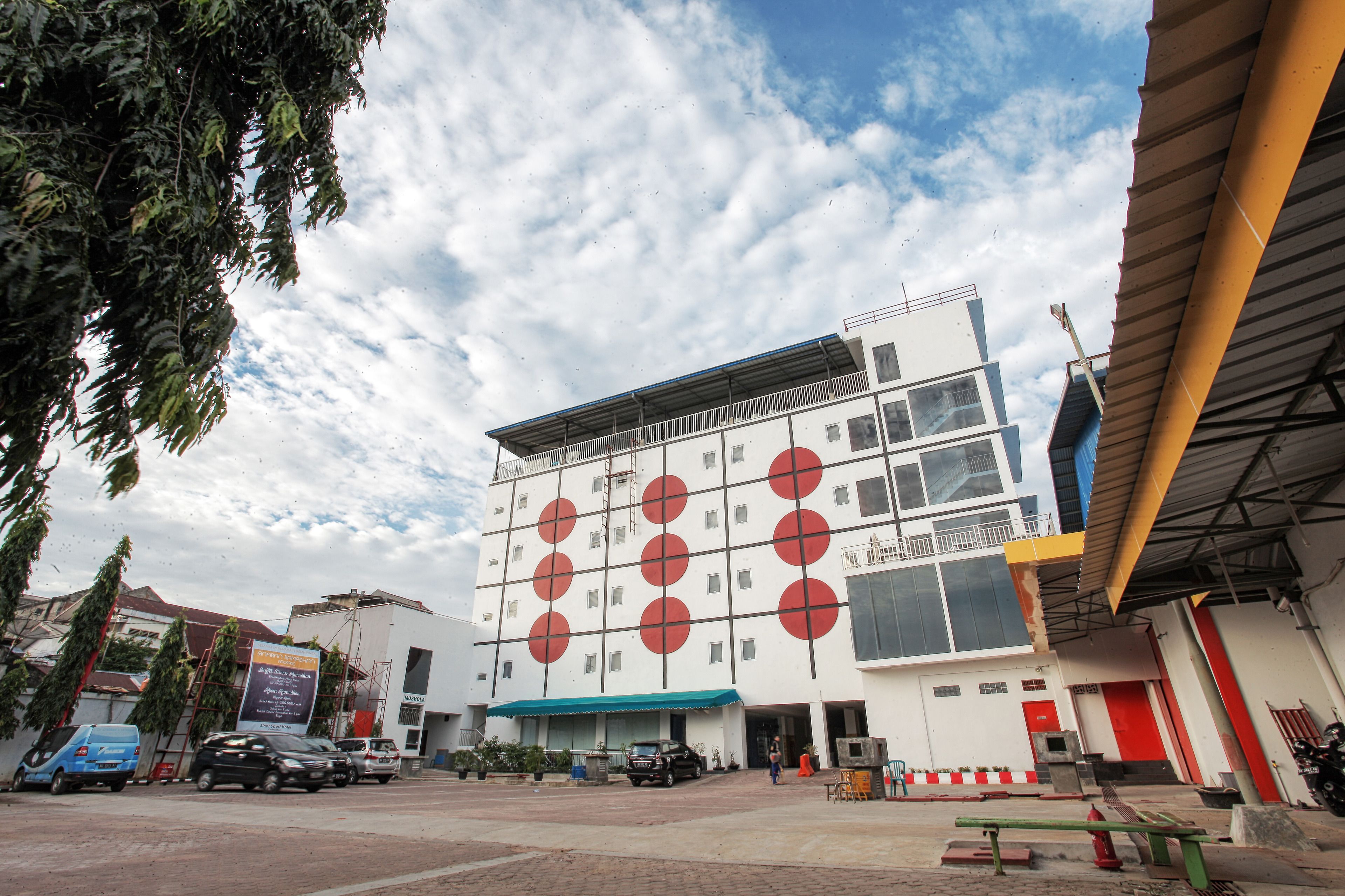 A multi-story building with a distinctive facade featuring large red circles.